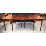 A large antique mahogany two section dining table with two folding centre legs 74 x 201 x 130 cm.