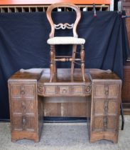 An antique oak dressing table with seven drawers together with a Balloon back Chair 78 x 121 x 50 cm
