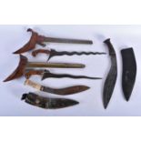 FOUR MIDDLE EASTERN KUKRI TYPE KNIVES. Largest 48 cm long. (4)