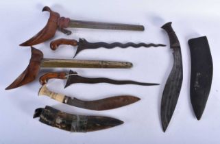 FOUR MIDDLE EASTERN KUKRI TYPE KNIVES. Largest 48 cm long. (4)