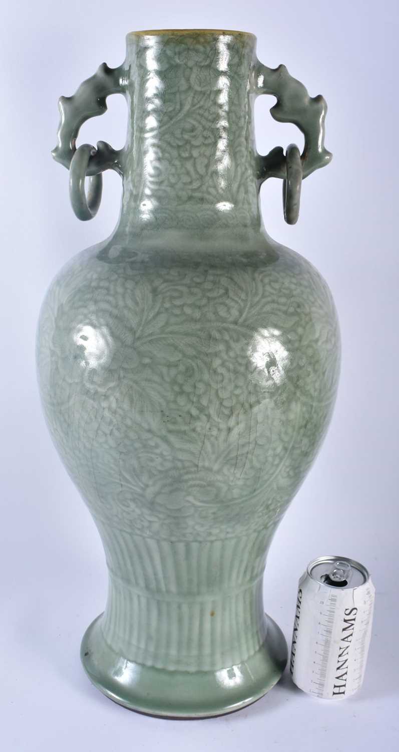 A LARGE 18TH/19TH CENTURY CHINESE TWIN HANDLED CELADON VASE decorated with foliage and vines. 54