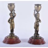 AN UNUSUAL PAIR OF MID 19TH CENTURY BRONZE ETHNOGRAPHICAL CANDLESTICKS formed as a Nubian boy and