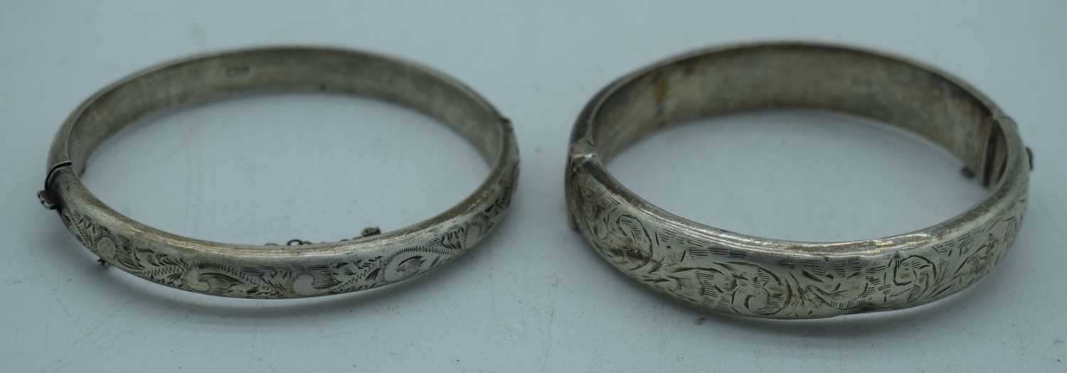 TWO SILVER BANGLES. Chester 1955 & Birmingham 1960. 33 grams. Largest 6 cm wide. (2)