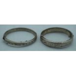 TWO SILVER BANGLES. Chester 1955 & Birmingham 1960. 33 grams. Largest 6 cm wide. (2)