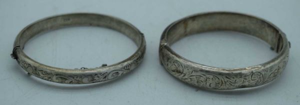 TWO SILVER BANGLES. Chester 1955 & Birmingham 1960. 33 grams. Largest 6 cm wide. (2)