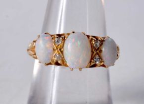 An 18 Carat Gold and Three Stone Opal Ring set with Diamonds... Stamped 18CT, Size N, weight 4.3g