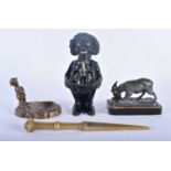 AN ANTIQUE CAST IRON GOLLY MONEY BOX together with a bronze dish etc. Largest 18cm long. (4)