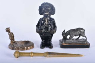 AN ANTIQUE CAST IRON GOLLY MONEY BOX together with a bronze dish etc. Largest 18cm long. (4)