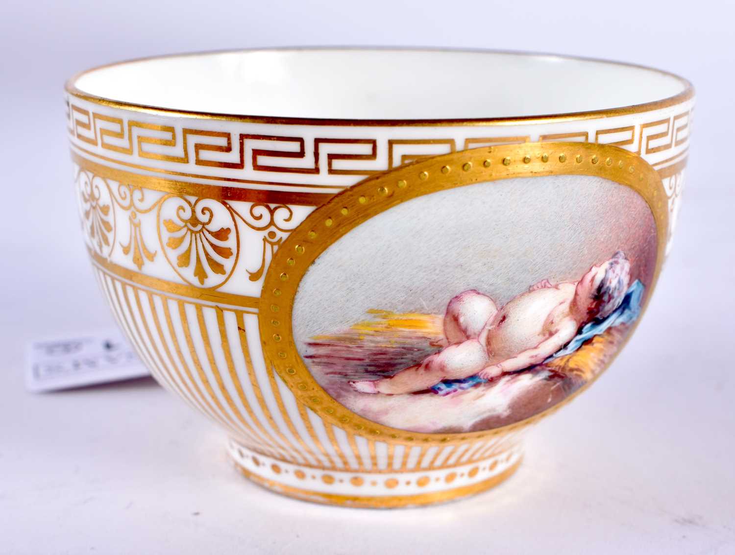 Minton teacup and saucer painted with a naked baby laying on a straw mattress, globe mark, made - Image 8 of 19