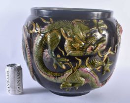 A VERY LARGE BRETBY POTTERY DRAGON JARDINIERE modelled pursuing a flaming pearl. 34 cm x 34 cm.