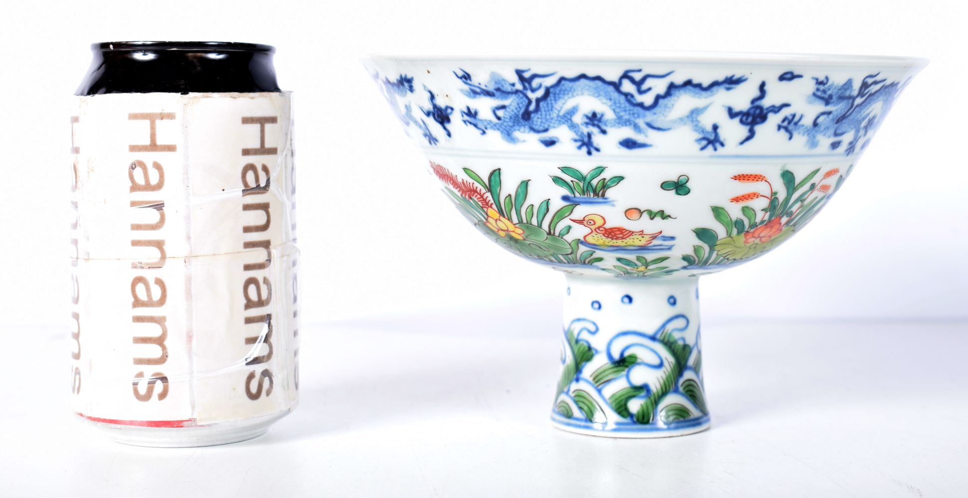 A Chinese porcelain Stem cup with symbols to the interior and Dragons 11 x 17 cm.