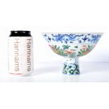 A Chinese porcelain Stem cup with symbols to the interior and Dragons 11 x 17 cm.