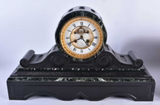 A late 19th Century French black slate and variegated green marble mantel clock with eight day