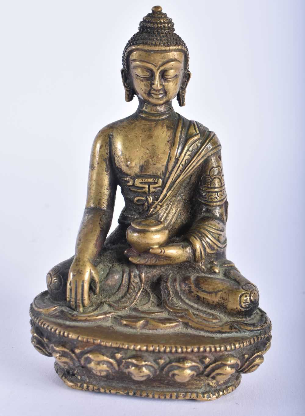 A 19TH CENTURY CHINESE BRONZE FIGURE OF A SEATED BUDDHA modelled upon a lotus capped base. 12 cm x 6