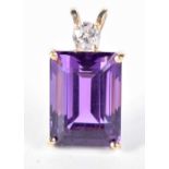 A GOLD DIAMOND AND AMETHYST PENDANT. 5.4 grams. 2.5 cm x 1.25cm.