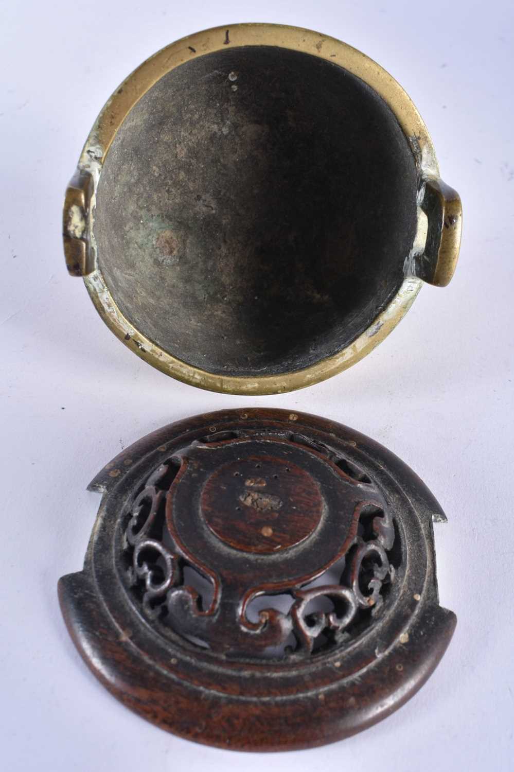 A 19TH CENTURY CHINESE TWIN HANDLED BRONZE QING CENSER, with hardwood cover. 11cm x 9 cm. - Image 4 of 14