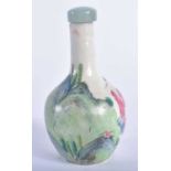 A 19TH CENTURY CHINESE FAMILLE ROSE PORCELAIN BULBOUS SNUFF BOTTLE AND STOPPER Qing, painted with