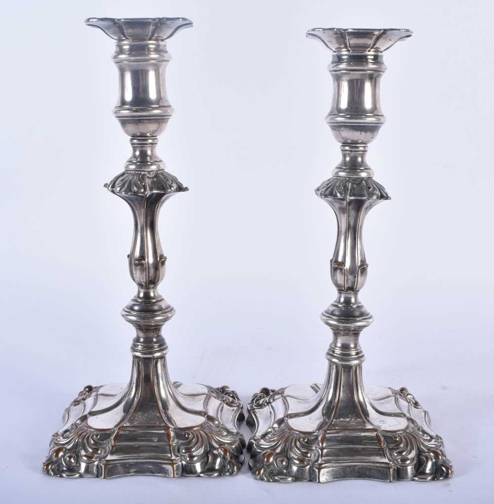 A PAIR OF GEORGE III OLD SHEFFIELD PLATED CANDLESTICKS. 1134 grams. 23 cm x 11cm.