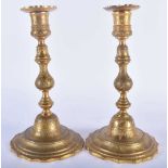 A PAIR OF 19TH CENTURY MIDDLE EASTERN TURKISH BRONZE CANDLESTICKS possibly Tombac. 24 cm high.