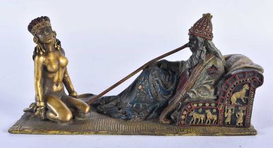 A COLD PAINTED BRONZE FIGURE OF A SEATED MALE beside a nude female. 18cm x 8 cm.