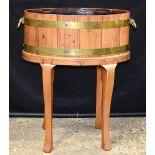 A brass banded oval oak planter 70 x 58 x 54 cm