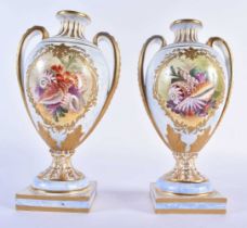 Minton pair of vases painted with sea shells in elaborate gilt panels on a marble ground. 20 cm high