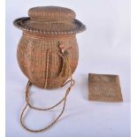 AN UNUSUALLY FINE TRIBAL CARVED WICKER BASKET AND COVER together with a similar wicker sliding pouch