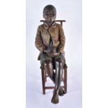 A Blackamoor Figure of a Boy seated on a Chair. Boy 40cm x 15cm x 14cn. Chair 34cm x 14cm x 13cm (