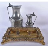 TWO PEWTER FLAGONS together with a bronze desk stand. Largest 30cm x 22 cm. (3)