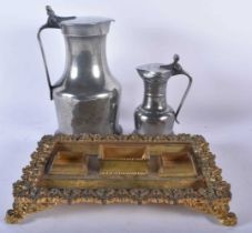 TWO PEWTER FLAGONS together with a bronze desk stand. Largest 30cm x 22 cm. (3)