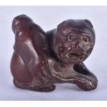 A Japanese Hardwood Netsuke carved as a dog with a Pup on its back. 4cm x 4cm