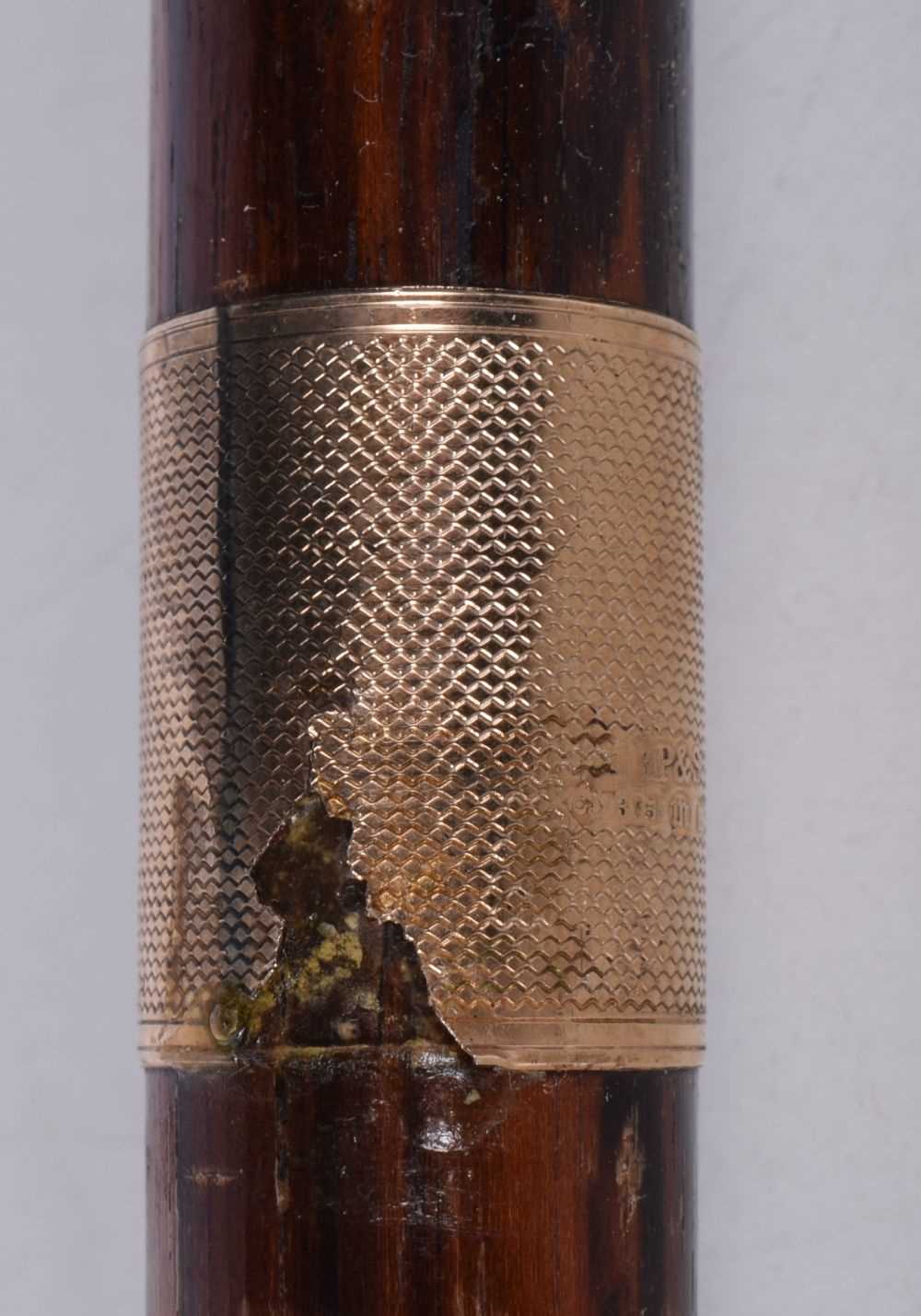 A wooden walking cane with a 9 Ct gold collar stamed 1928 together with another leather encased - Image 4 of 14