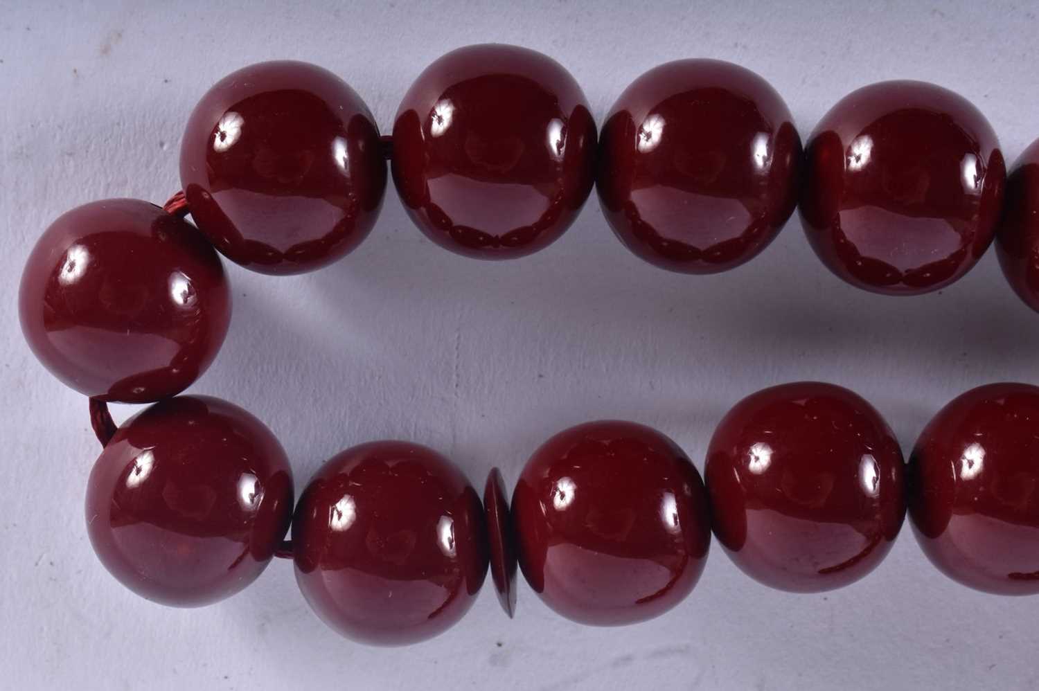 A TURKISH CHERRY AMBER TYPE TESBIH NECKLACE. 93 grams. 94 cm long. - Image 2 of 4