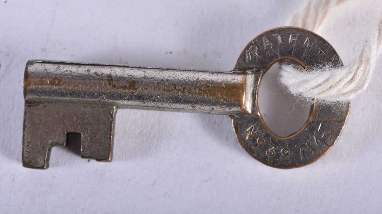 A PAIR OF ANTIQUE HANDCUFFS together with a similar padlock. Largest 24 cm long. (3) - Image 4 of 7