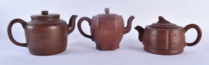 THREE CHINESE YIXING POTTERY TEAPOTS AND COVERS possibly Republican period. Largest 20 cm wide. (3)