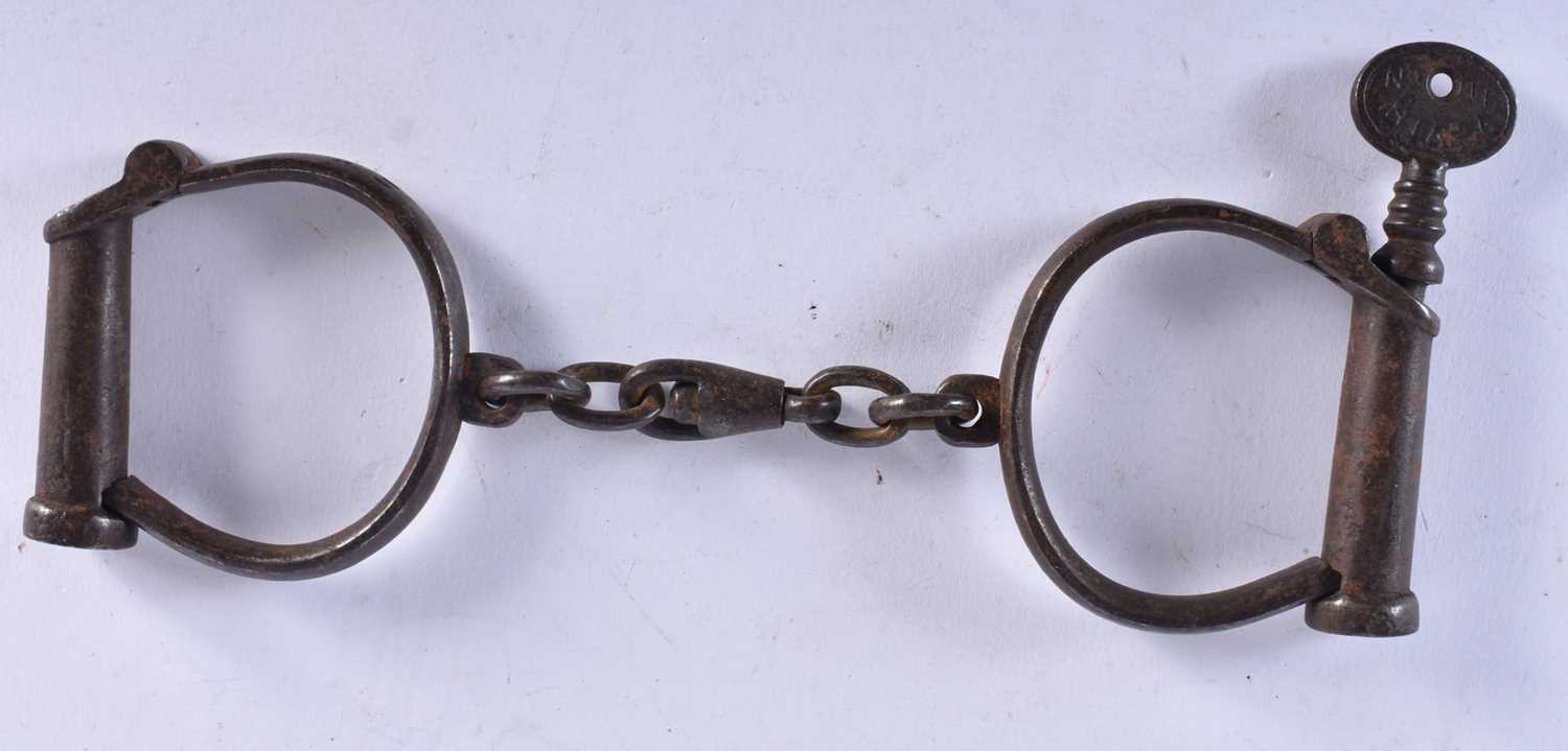 A PAIR OF ANTIQUE HANDCUFFS together with a similar padlock. Largest 24 cm long. (3) - Image 6 of 7