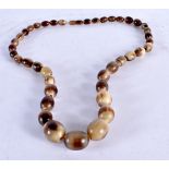 A Carved Horn Bead Necklace. 80cm long. Largest Bead 20mm, weight 106g
