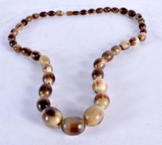 A Carved Horn Bead Necklace. 80cm long. Largest Bead 20mm, weight 106g