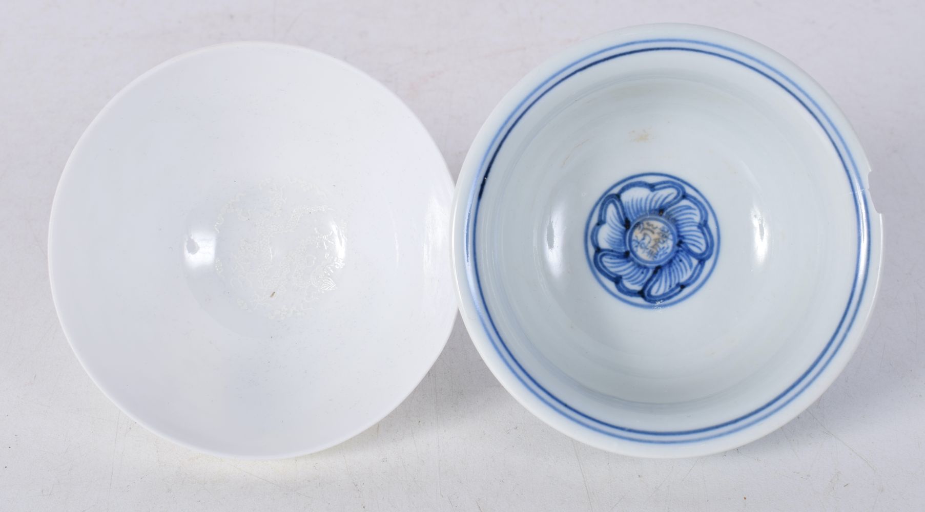 A Chinese porcelain blue and white tea bowl decorated with foliage together with another tea bowl - Image 5 of 6