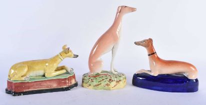 AN EARLY 19TH CENTURY STAFFORDSHIRE FIGURE OF A RECUMBENT HOUND Attributed to Enoch Wood, together