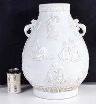 A large Chinese white glazed soft paste twin handled pot decorative in relief with Immortals 46 cm