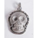 A DIAMOND SKULL PENDANT. 5.2 grams. 2.5 cm x 2 cm.