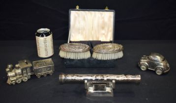A pair of cased silver plate brushes together with a quantity of plated Christening ware largest 6.