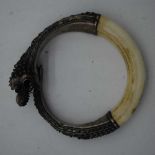 A LOVELY ANTIQUE INDIAN MIDDLE EASTERN SILVER DRAGON BEAST BANGLE. 153 grams. 9 cm x 7.5 cm.