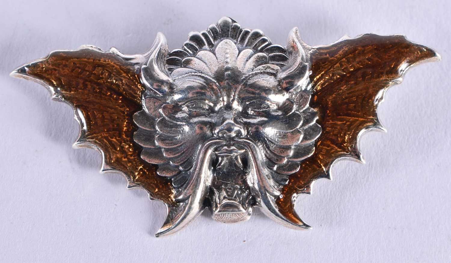 A Silver and Enamel Green Man Brooch. 2.7cm x 5.4cm, weight 8.7g