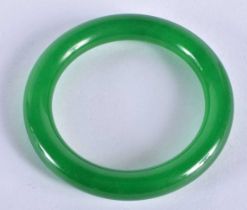 A CHINESE CARVED JADE BANGLE 20th Century. 69.6 grams. 6.25cm diameter.