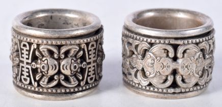 A pair of Chinese white metal Archers rings 2.5 x 3 cm (2).