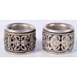 A pair of Chinese white metal Archers rings 2.5 x 3 cm (2).