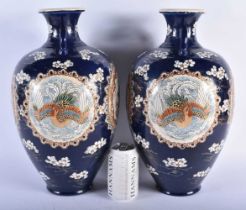 A LARGE PAIR OF LATE 19TH CENTURY JAPANESE MEIJI PERIOD SATSUMA VASES painted in relief with