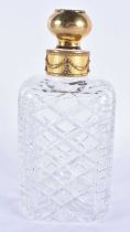 A CONTINENTAL SILVER GILT AND DIAMOND CUT GLASS DECANTER. 22 cm high.